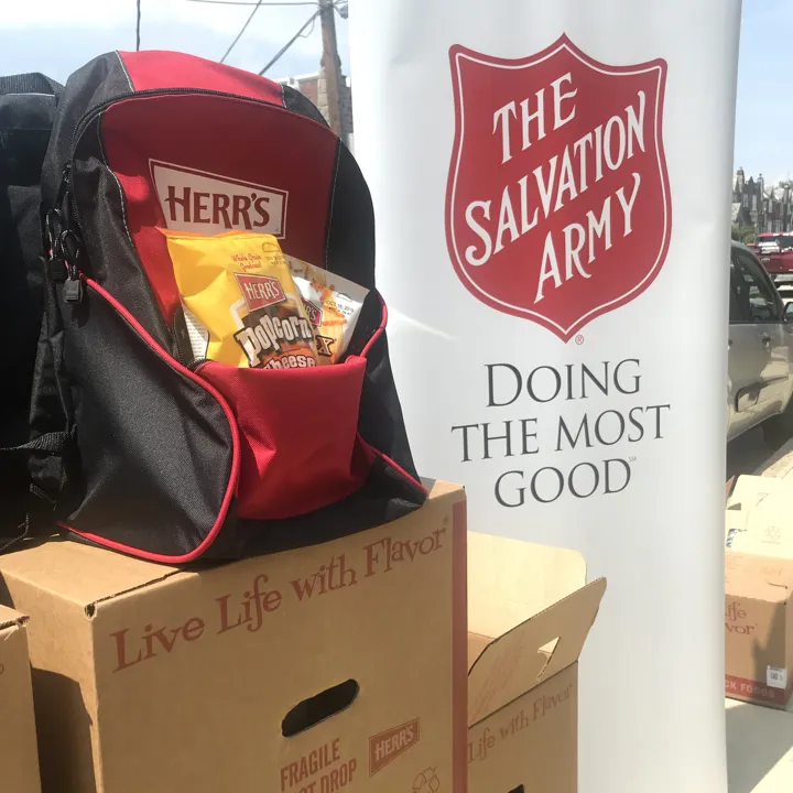 Salvation Army Back to School Program with a Herr's backpack and snacks