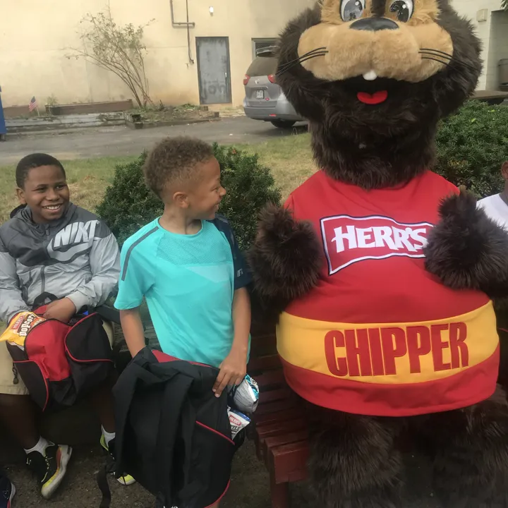 Chipper giving a thumbs up to the camera at the Back to School Program