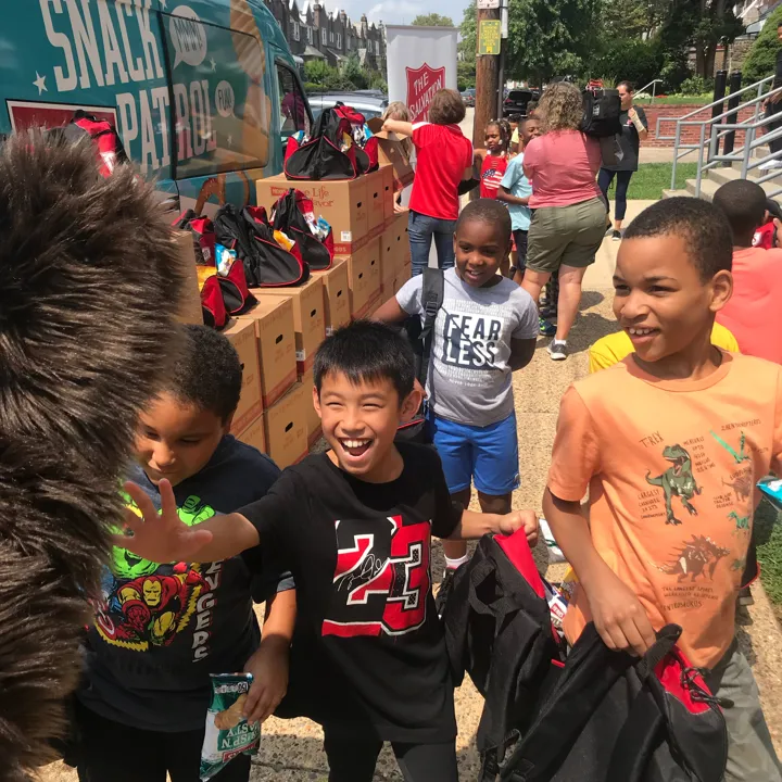 Kids getting their backpacks at the Back to School Program