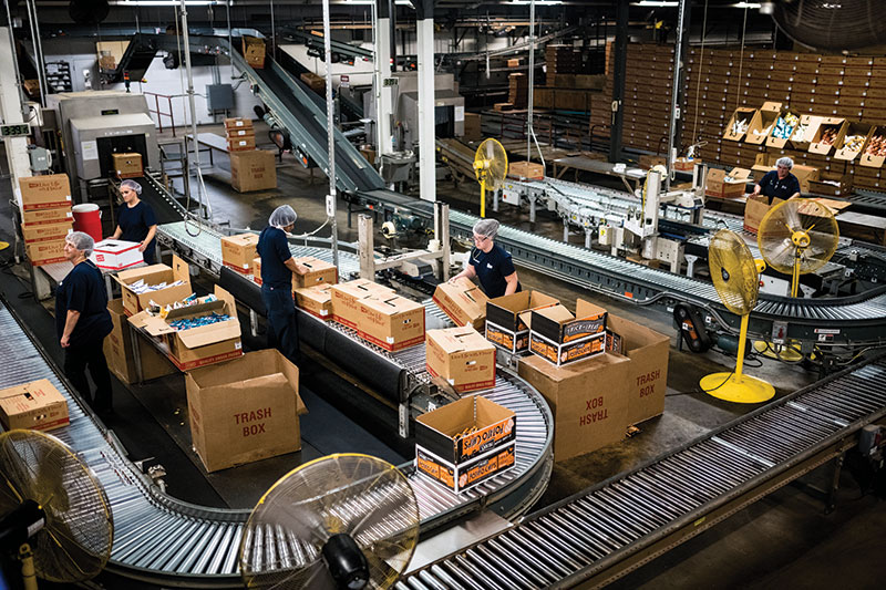 Herr's employees packing boxes of Herr's snacks